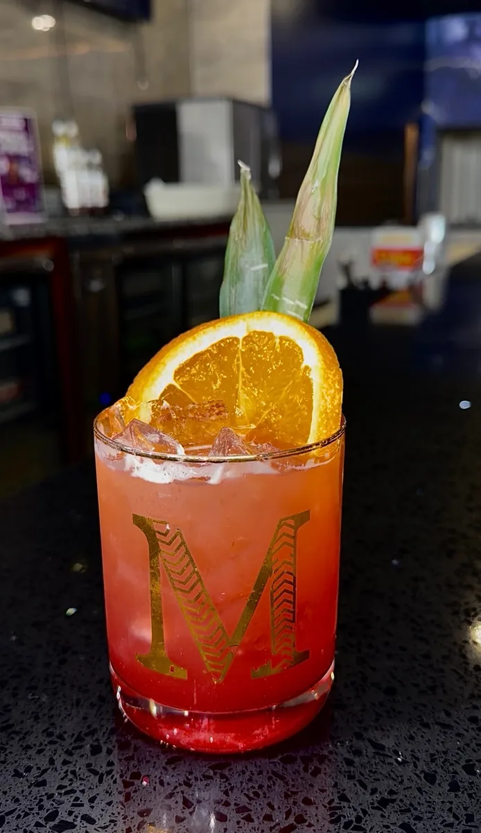 Mystic branded cocktail glass with tropical garnish