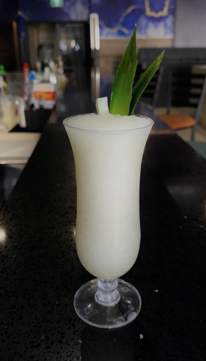 Piña colada in hurricane glass at Mystic Caribbean