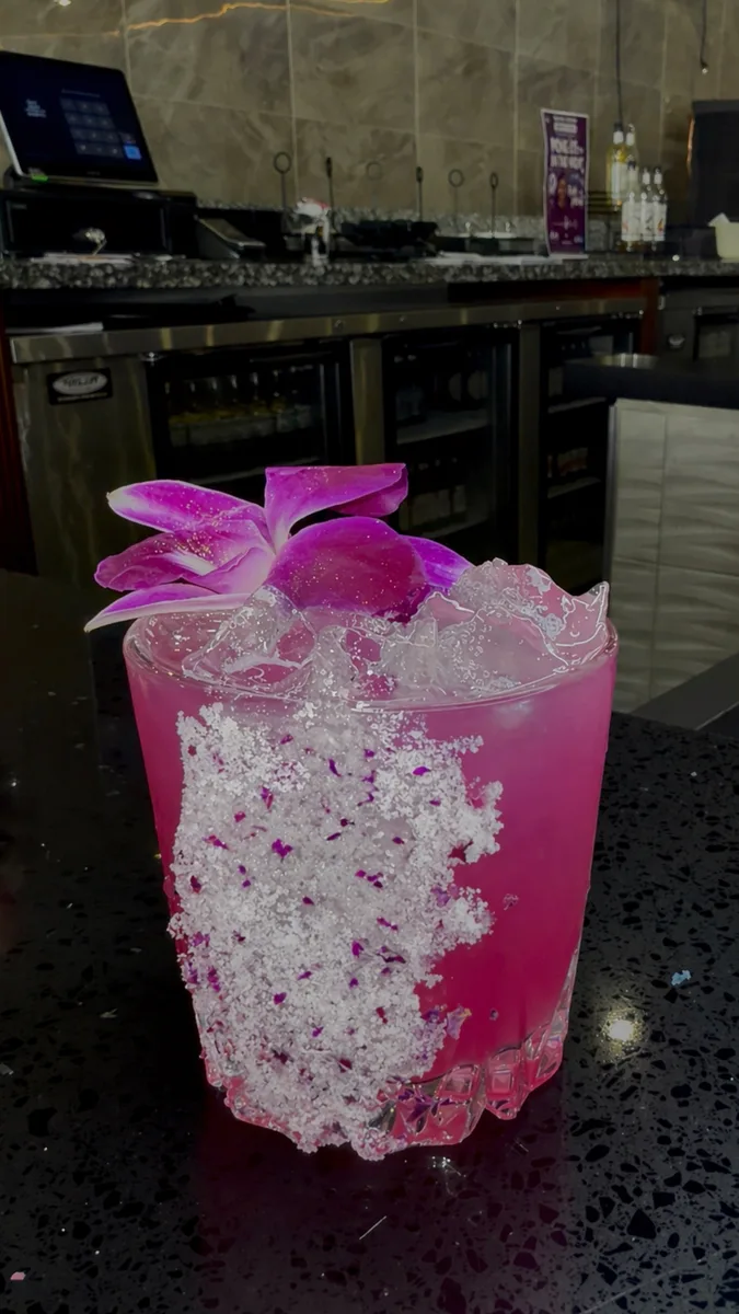 Pink orchid garnish cocktail at Mystic Caribbean bar